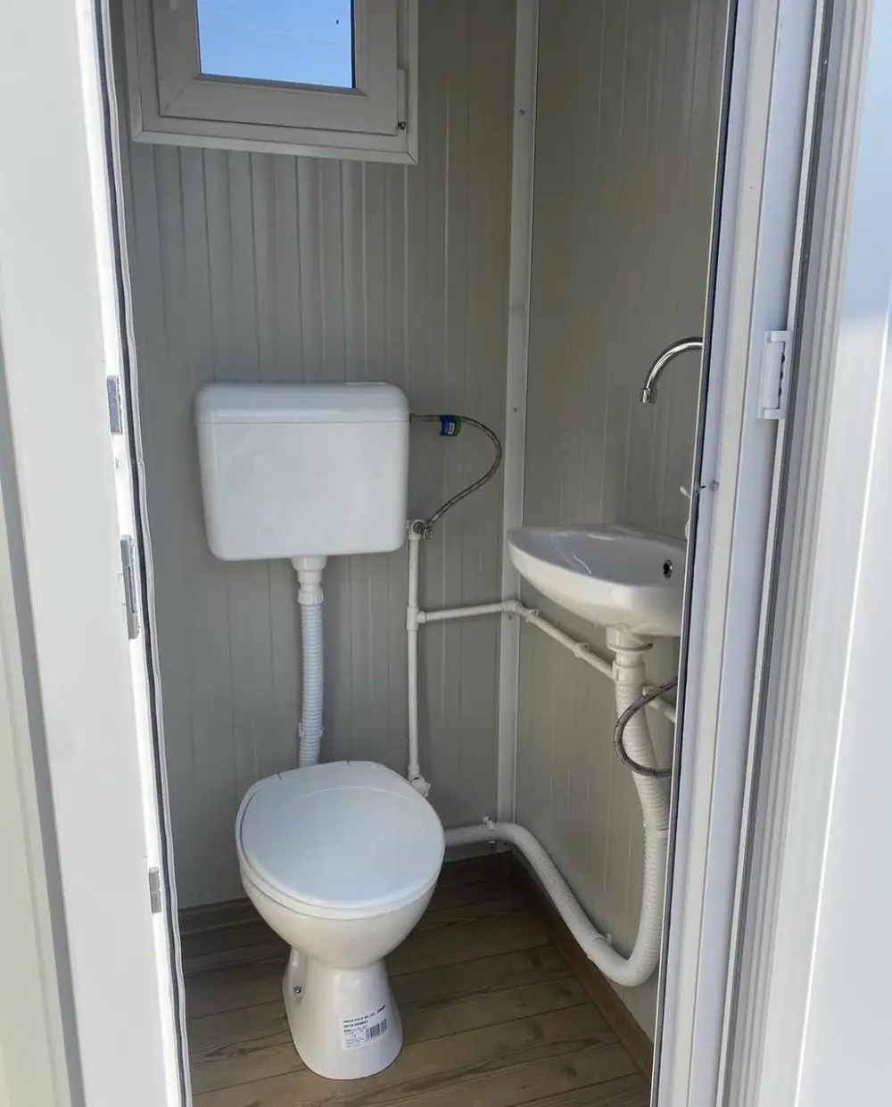 Cabin-style restroom interior with flush toilet and sink