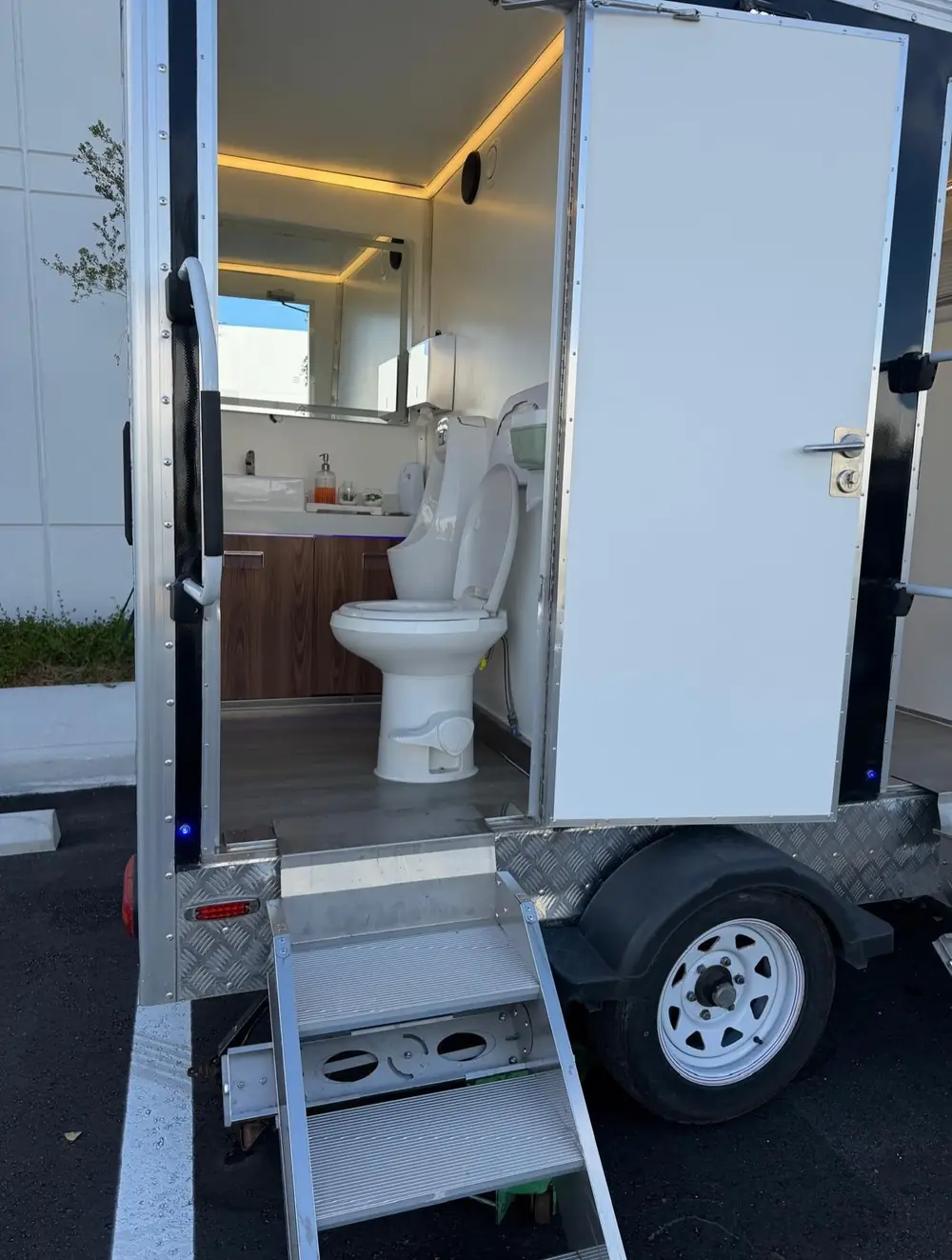 Luxury trailer interior with toilet and wood vanity